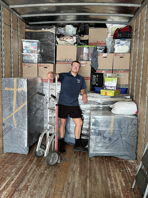 A smiling Pretty Strong Movers crew member on the job